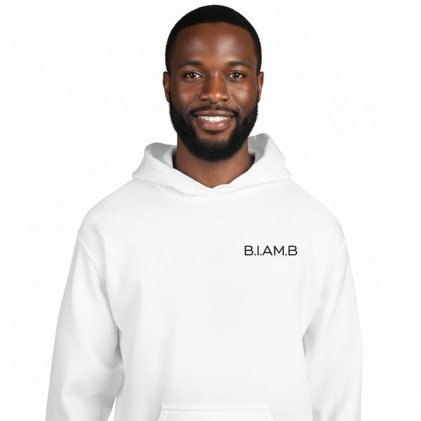 Black man wearing a white B.I.AM.B Minimal Logo Hoodie against a white background.