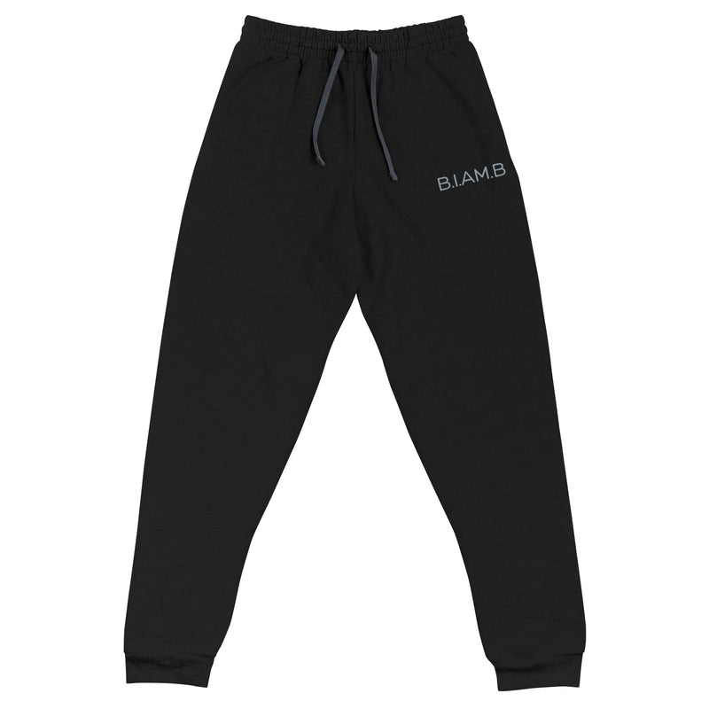 Flat lay of black B.I.AM.B joggers with a small logo on the left thigh and drawstring waist, displayed on a plain background.