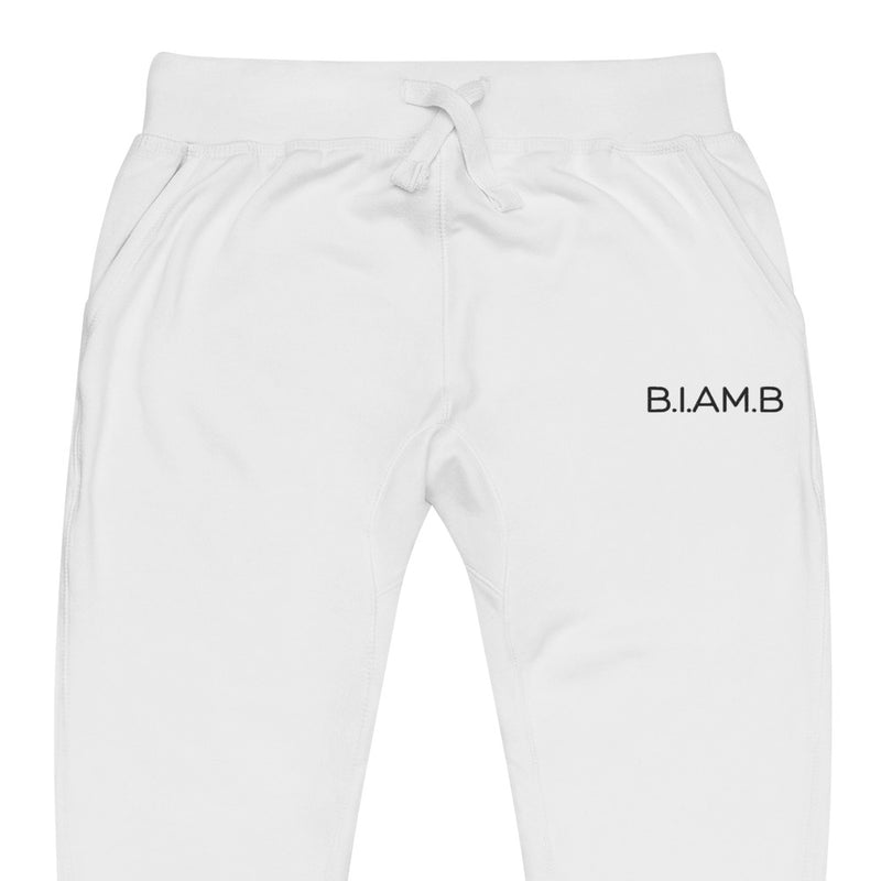 Close-up front view of white B.I.AM.B sweatpants with a drawstring waist and small logo on the right thigh, displayed flat on a plain background.