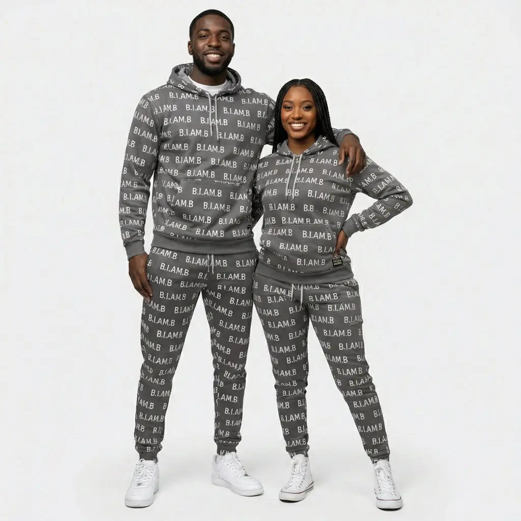 Couple wearing grey B.I.AM.B all-over print hoodie and jogger set, front view, streetwear tracksuit, Because I Am Black apparel