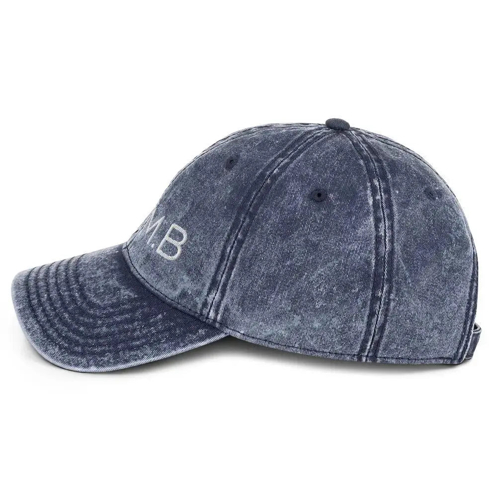 Left side view of B.I.AM.B Wear Your Power edition dad hat in vintage denim with embroidered logo