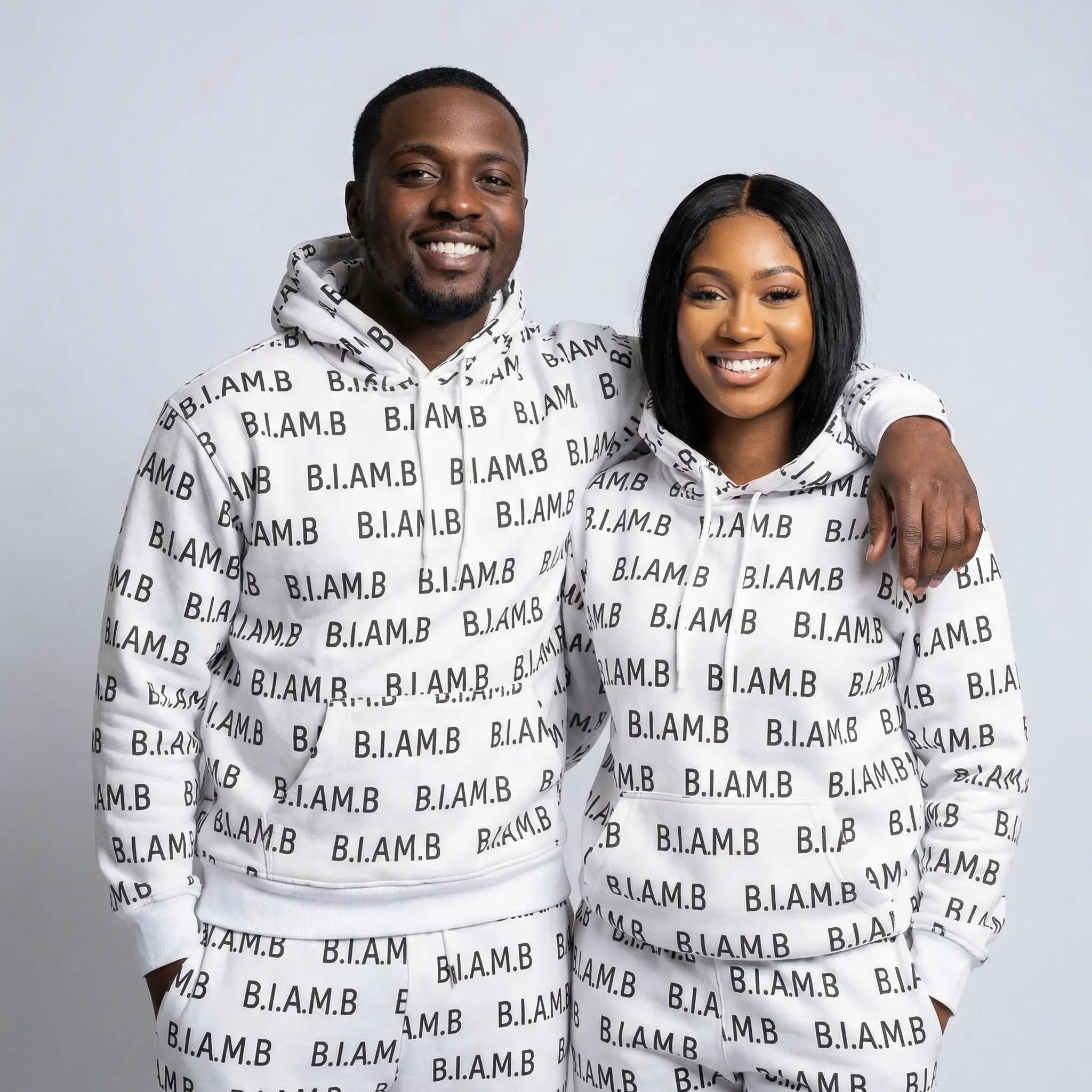 Models wearing white B.I.AM.B all-over print hoodie and jogger 